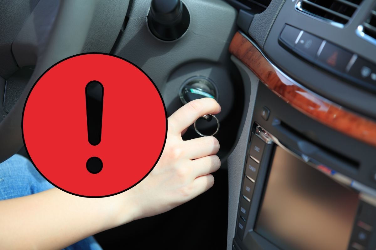 segnale di pericolo e persona che accende auto