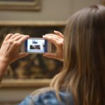 Ragazza che fotografa un quadro al museo