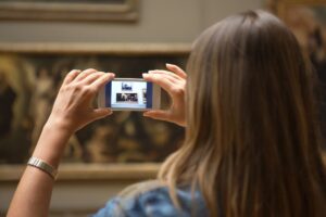 Ragazza che fotografa un quadro al museo