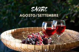 Uva e bicchiere di vino. Scritta "sagre agosto/settembre