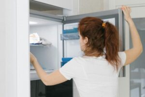 Una donna che apre il freezer