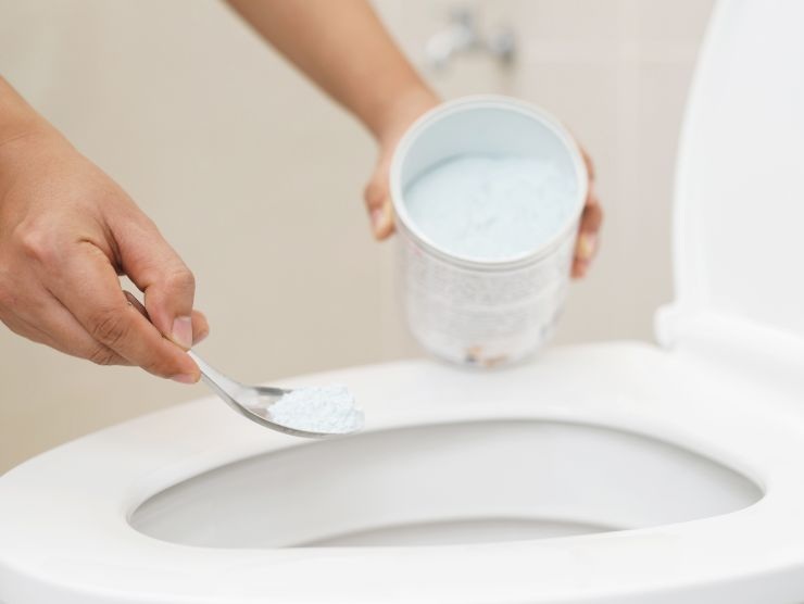 persona che versa bicarbonato nel wc